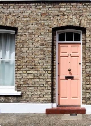 Right to Buy Mortgage | Front of a property with light brick and a pale pink front door