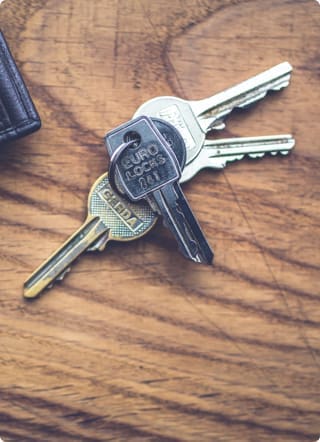 bunch of keys on dark wood table
