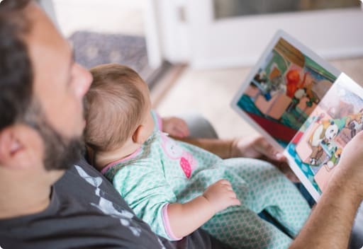 Father reading book with baby